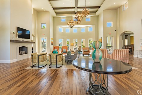 a living room with a table and a fireplace